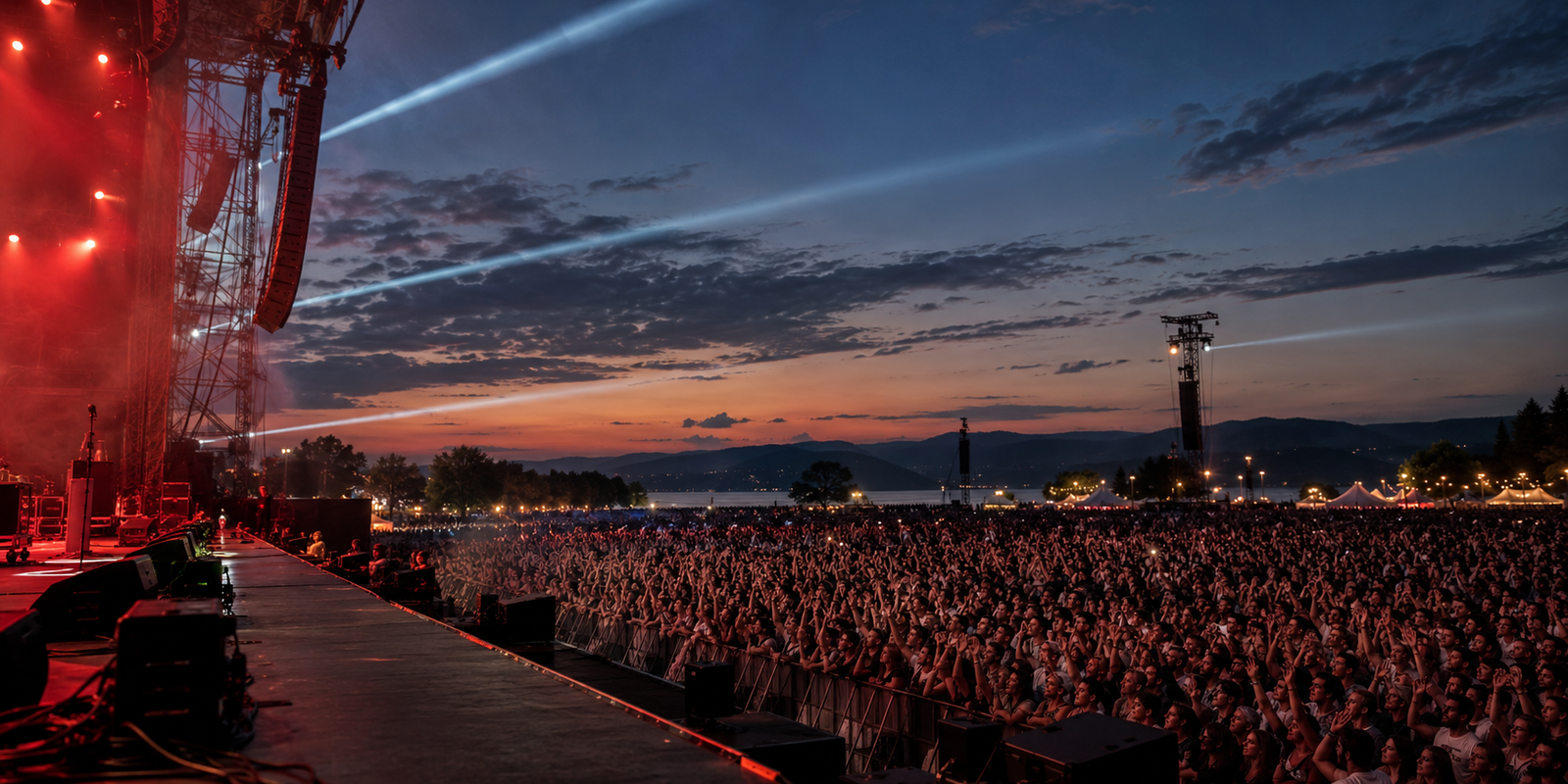 A festival crowd at dusk viewed from the stage